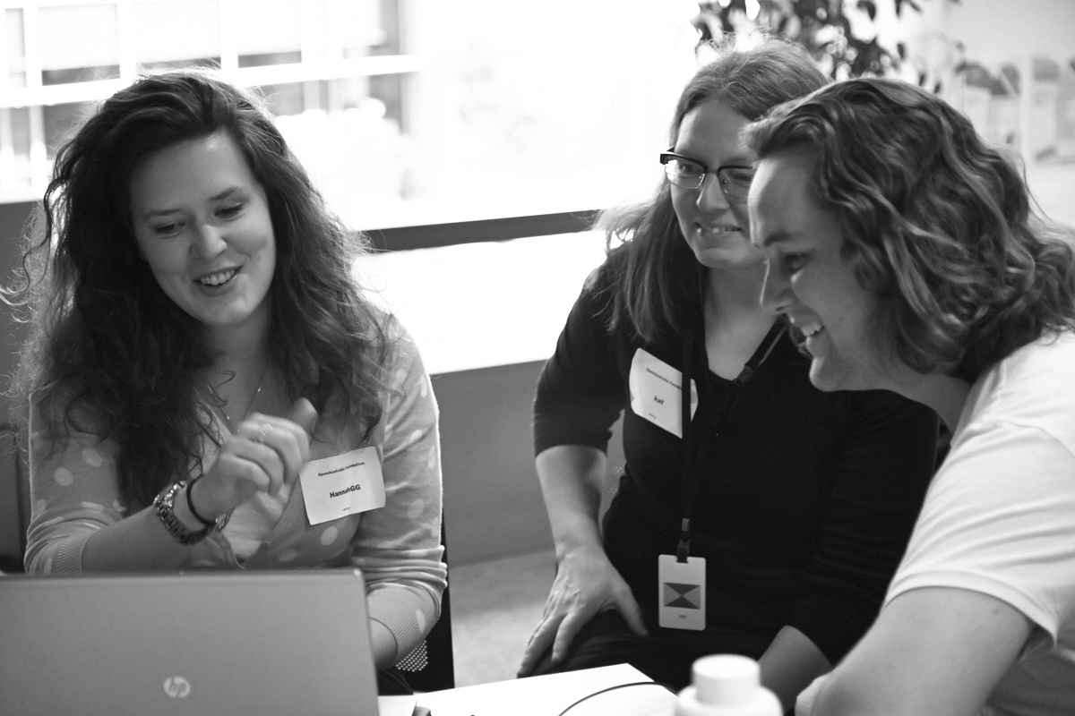 Photograph of civic hackers discussing a project at the OpenAustralia Hackfest 2014