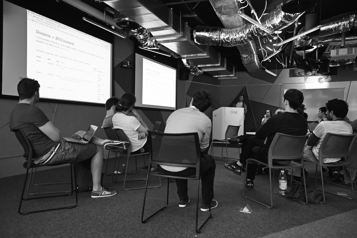 Photograph of Luke Bacon presenting the website to a crowd of volunteers.