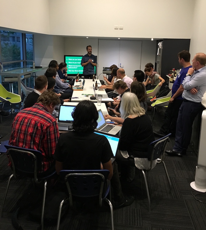Picture of Luke Bacon presenting to a group of people at laptops about FOI requests